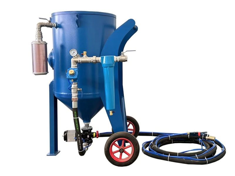 Industrial TS-600-1 sand blasting pot with blue body, black wheels (red rims), support legs, and connected hoses.
