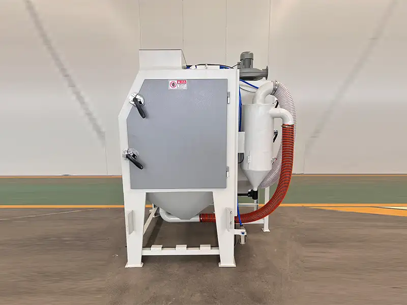Side view of TS9060 suction blasting cabinet with dust collection system for industrial abrasive blasting applications.