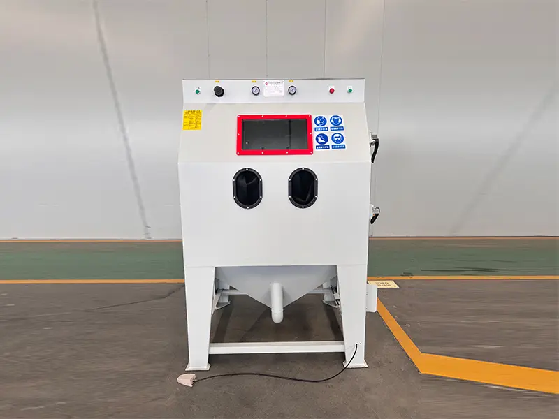 TS9060 suction blasting cabinet for industrial surface preparation, rust removal, deburring, and abrasive blasting of metal parts.