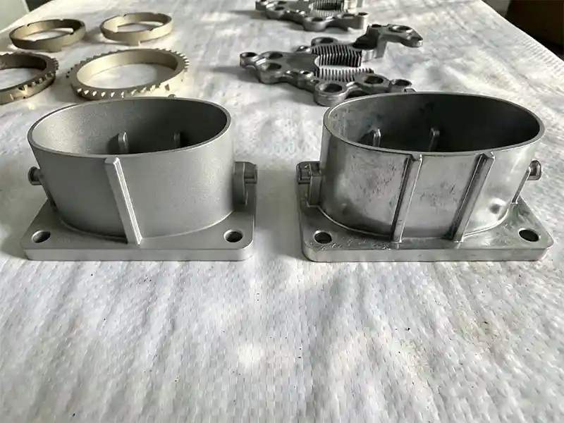 Aluminum cast housing before and after sandblasting surface finishing with suction blasting cabinet