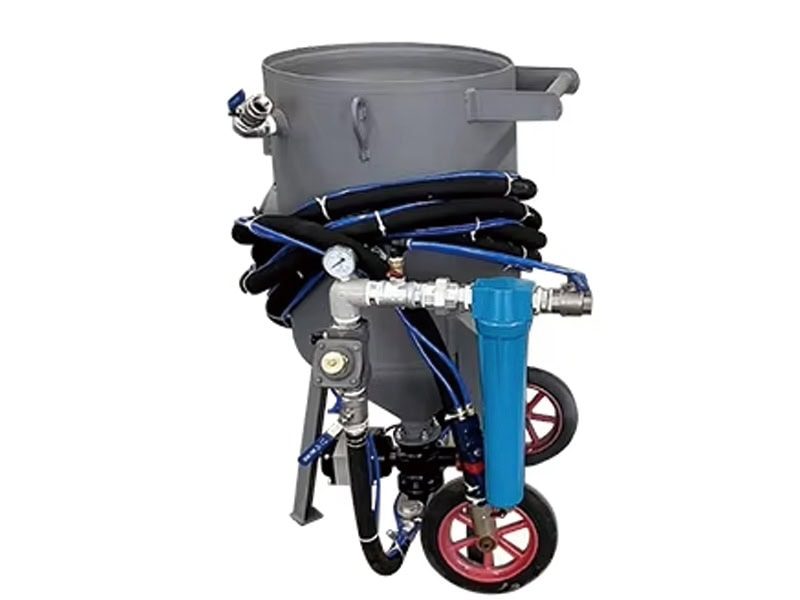 Industrial TS-500-1 sand blasting pot with wheels, blue-gray design, and attached hoses.