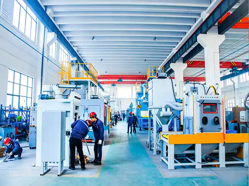 Tsblasting factory workshop workers assembling industrial sand blasting machine and shot blasting equipment