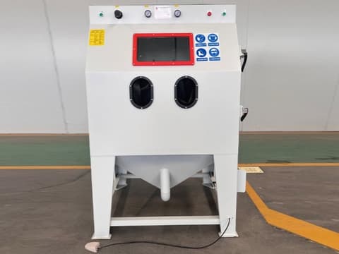 White TS-9060 manual sandblasting cabinet with hand-access openings, red control panel, and industrial design.