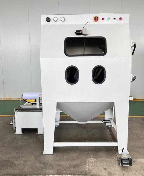 Industrial-grade wet blasting machine with emergency stop controls, viewing window, and foot pedal operation - ideal for rust removal and surface preparation in manufacturing facilities.