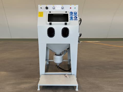 White Pressure Sand Blasting Cabinet with control knobs, viewing window, and front access ports on industrial stand.
