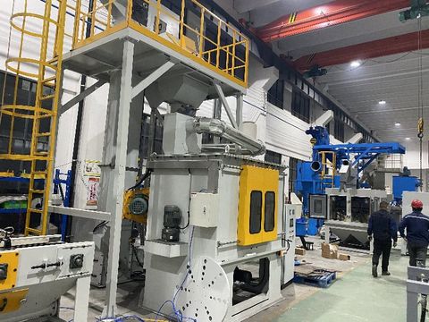 Industrial table-type shot blasting machine with blue housing and rotary worktable